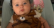 Manuela joined the competition — help win amazing prizes! baby, infant, child, curly_hair, blue_eyes, brown_outfit, teddy_bear, baby_seat, cushion, cartoon_character, indoors, cute, adorable, portrait, person, clothing, baby_toys, hand, expression, skin