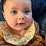 Manuela is registered to the contest to win money with this photo: baby, child, infant, face, hands, blue_eyes, curly_hair, sweater, clothing, portrait, indoor, cute, adorable, young_child, expression, human, person, skin, eyelashes, curious
