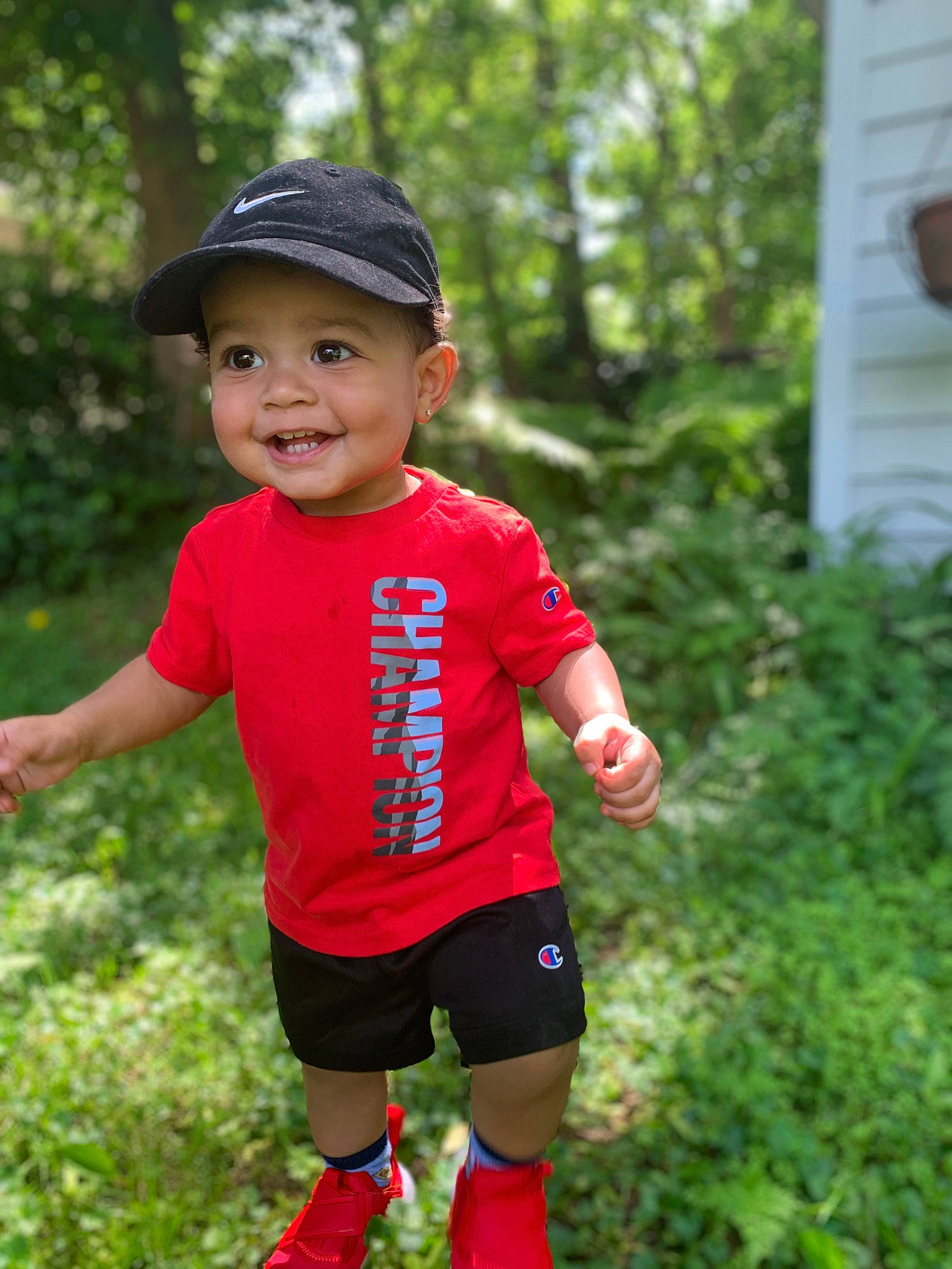Jamal is registered to the contest to win money with this photo: baby_toddler_clothing, baseball_cap, cap, clothing, cool, fun, grass, happy, hat, headwear, joy, leisure, magenta, people_in_nature, person, pink, plant, recreation, shorts, sleeve