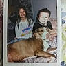 Mason Jar joined the competition — help win amazing prizes! children, boy, girl, dog, pet, smiling, portrait, indoor, bedroom, bed, blanket, family, siblings, large_dog, brown_dog, white_markings, sitting, lying_down, printed_photo, handwritten_year