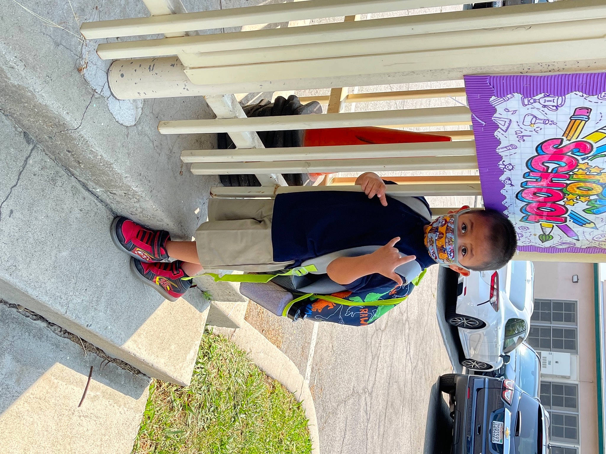 Liam is registered to the contest to win money with this photo: art, building, car, child, concrete, facade, fun, house, leisure, person, plant, recreation, t_shirt, tire, toddler, tree, vacation, visual_arts, wheel, wood