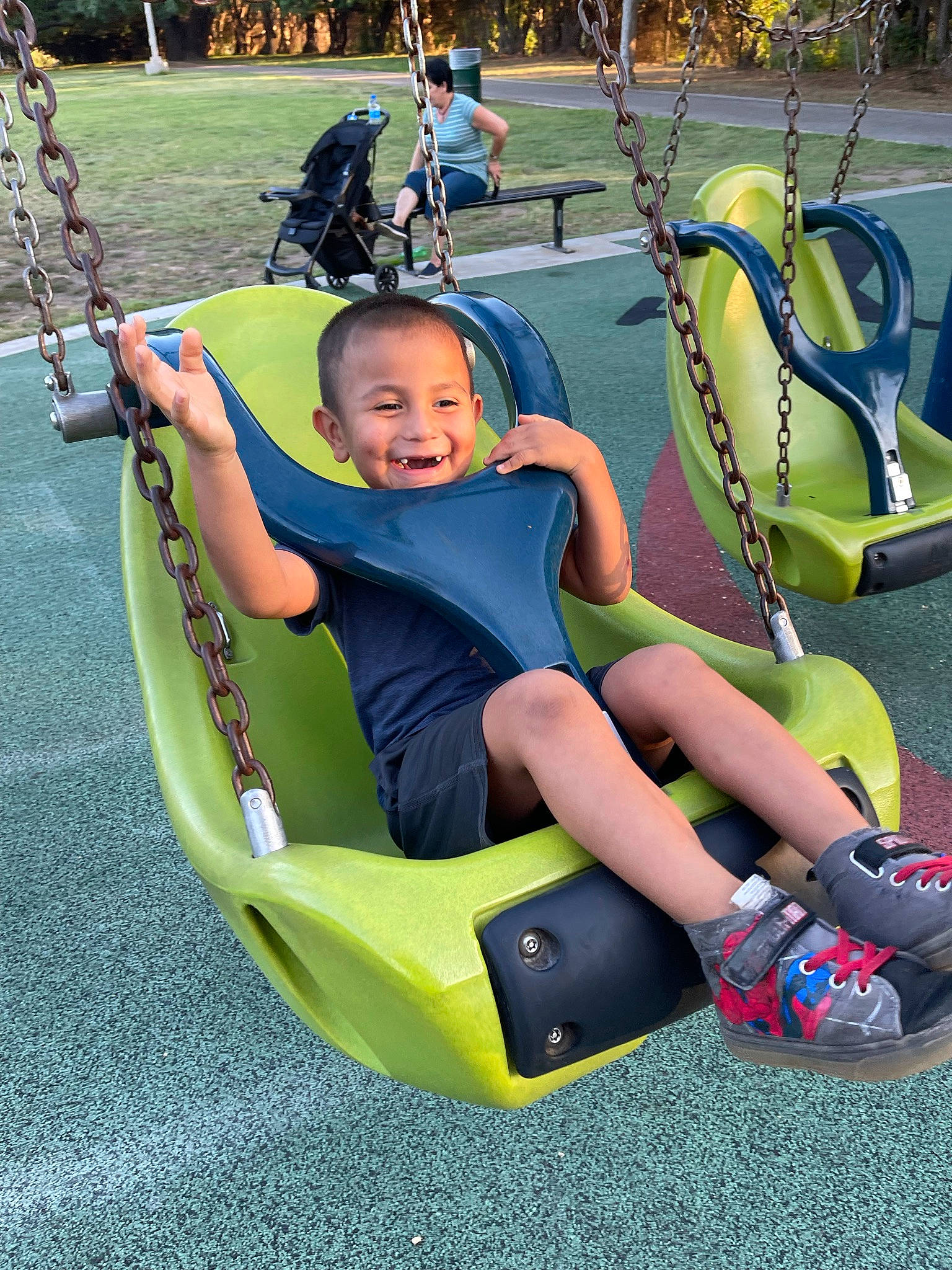 Liam joined the competition — help win amazing prizes! child, city, fun, grass, happy, joy, leisure, motor_vehicle, outdoor_play_equipment, outdoor_recreation, person, recreation, shorts, sitting, smile, snapshot, summer, swing, tire, toddler