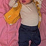 Meilani is registered to the contest to win money with this photo: accessories, baby, bed, bonnet, boot, clothing, costume, couch, face, footwear, furniture, glove, hat, head, jeans, pants, person, photography, portrait, shoe