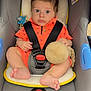 Kenzo participe au concours pour gagner de l'argent avec cette photo : baby, infant, child, stroller, car_seat, orange_clothing, toy, pacifier, seat_belt, indoor, foot, hand, face, wide_eyes, curly_hair, soft_toy, plush, child_safety, kindergarten, kinderkraft