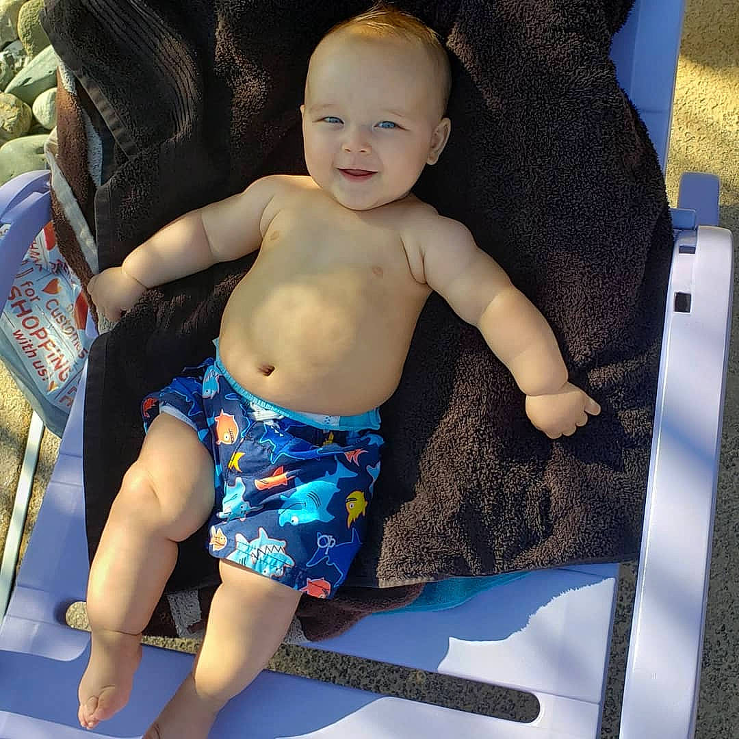 Kruz is registered to the contest to win money with this photo: arm, baby, child, leg, person, product, sitting, toddler