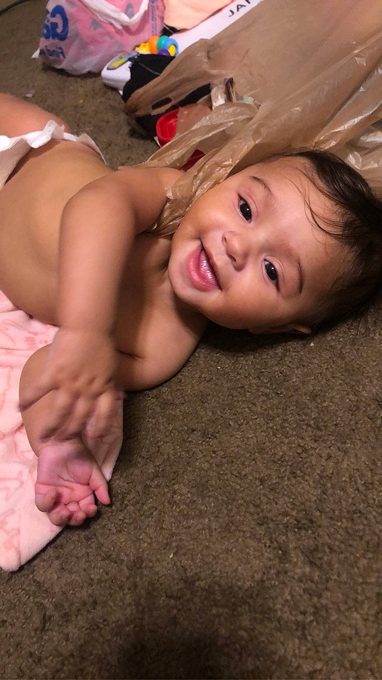 Tiana is registered to the contest to win money with this photo: cheek, chin, elbow, facial_expression, fun, gesture, grass, hair, hairstyle, happy, human_body, human_leg, leg, mouth, nose, person, pink, skin, smile, thigh