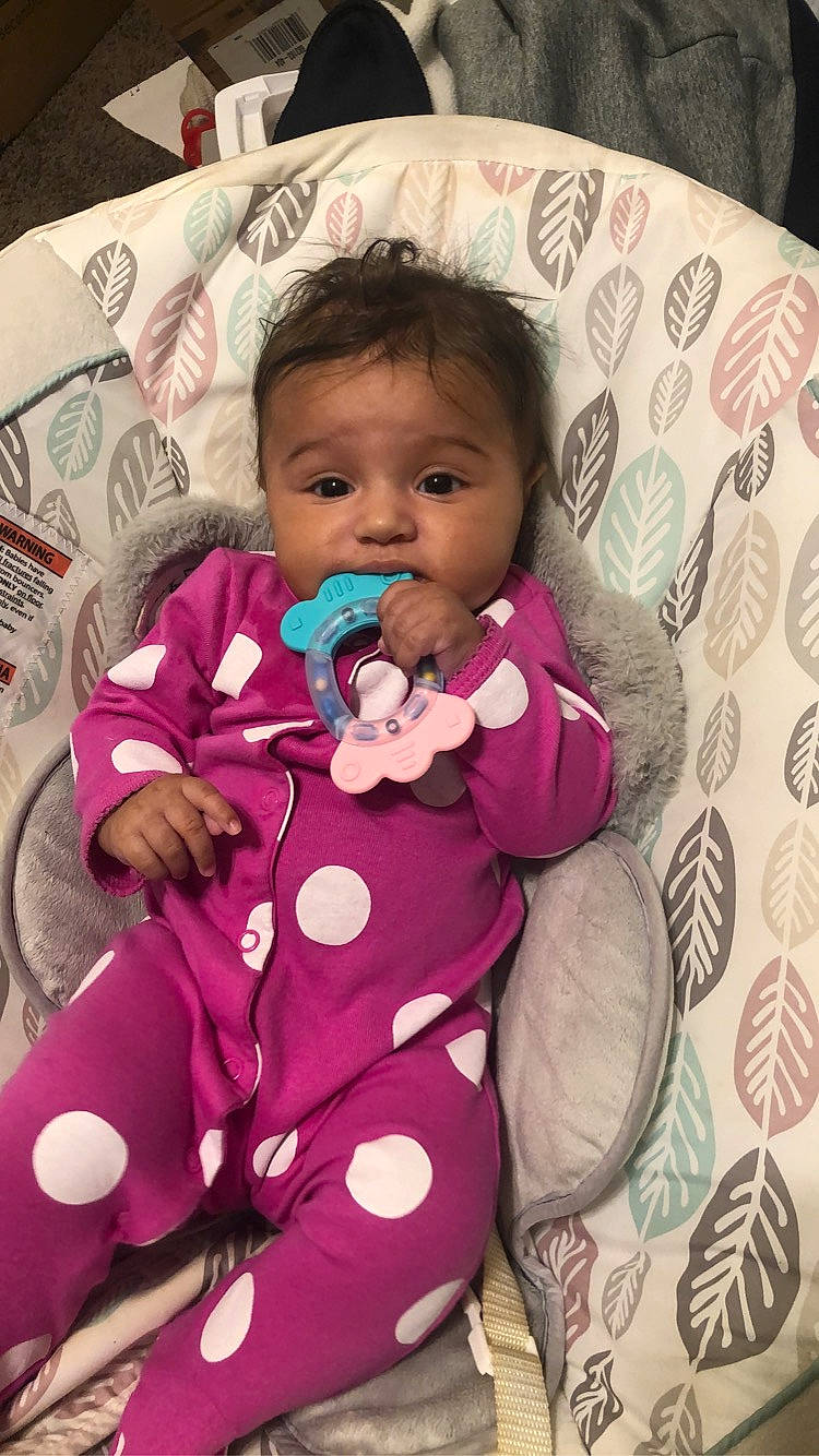 Tiana is registered to the contest to win money with this photo: baby, baby_toddler_clothing, cheek, comfort, eye, face, finger, hairstyle, happy, head, iris, lip, nose, outerwear, person, pink, purple, skin, sleeve, textile