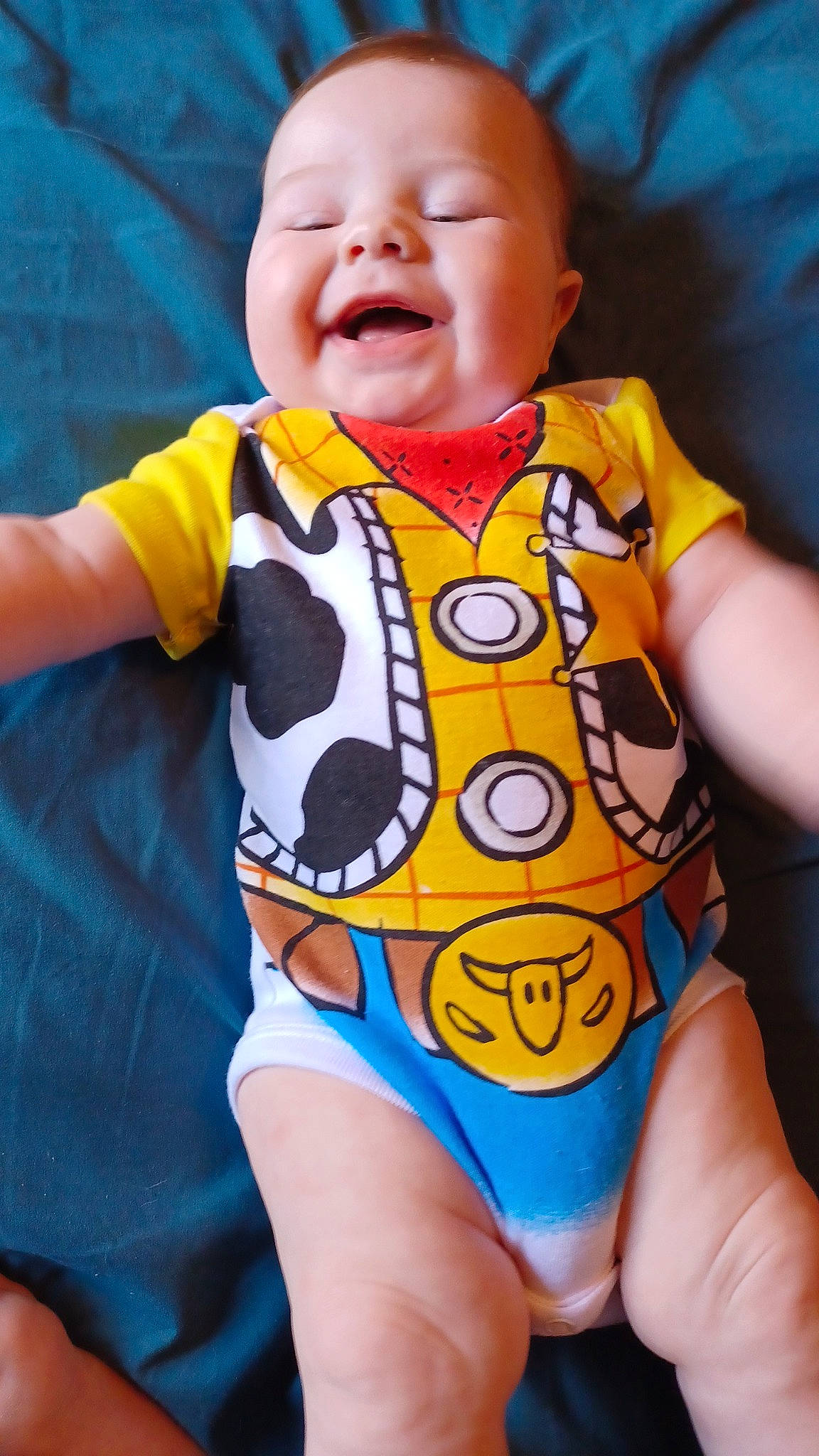 Phoenix is registered to the contest to win money with this photo: baby, baby_toddler_clothing, cheek, eye, face, happy, human_body, infant_bodysuit, mouth, neck, nose, orange, organ, person, pink, skin, sleeve, smile, thigh, toddler