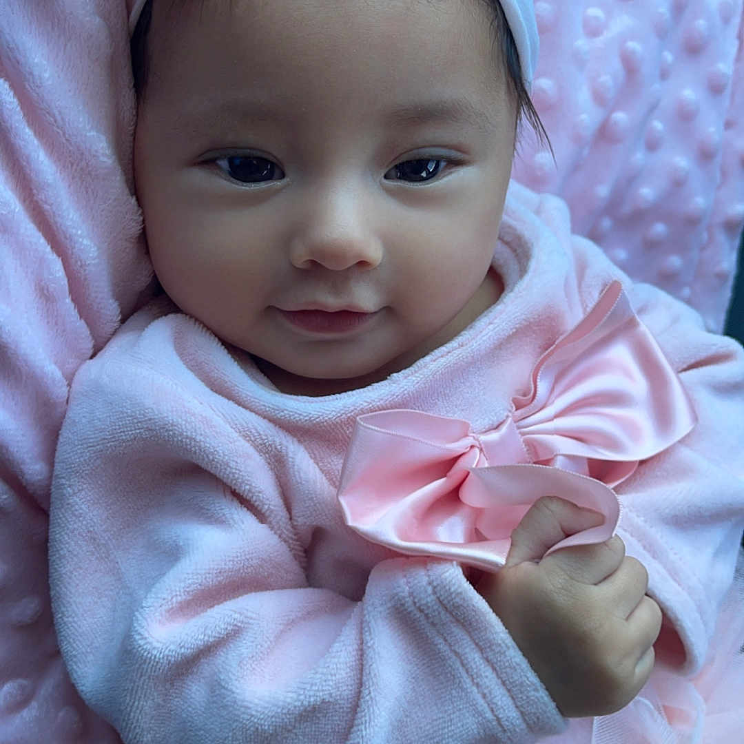 Zahira joined the competition — help win amazing prizes! accessories, baby, bodypart, bonnet, clothing, dress, face, finger, hand, happy, hat, head, headband, hood, newborn, person, photography, portrait, sitting, smile