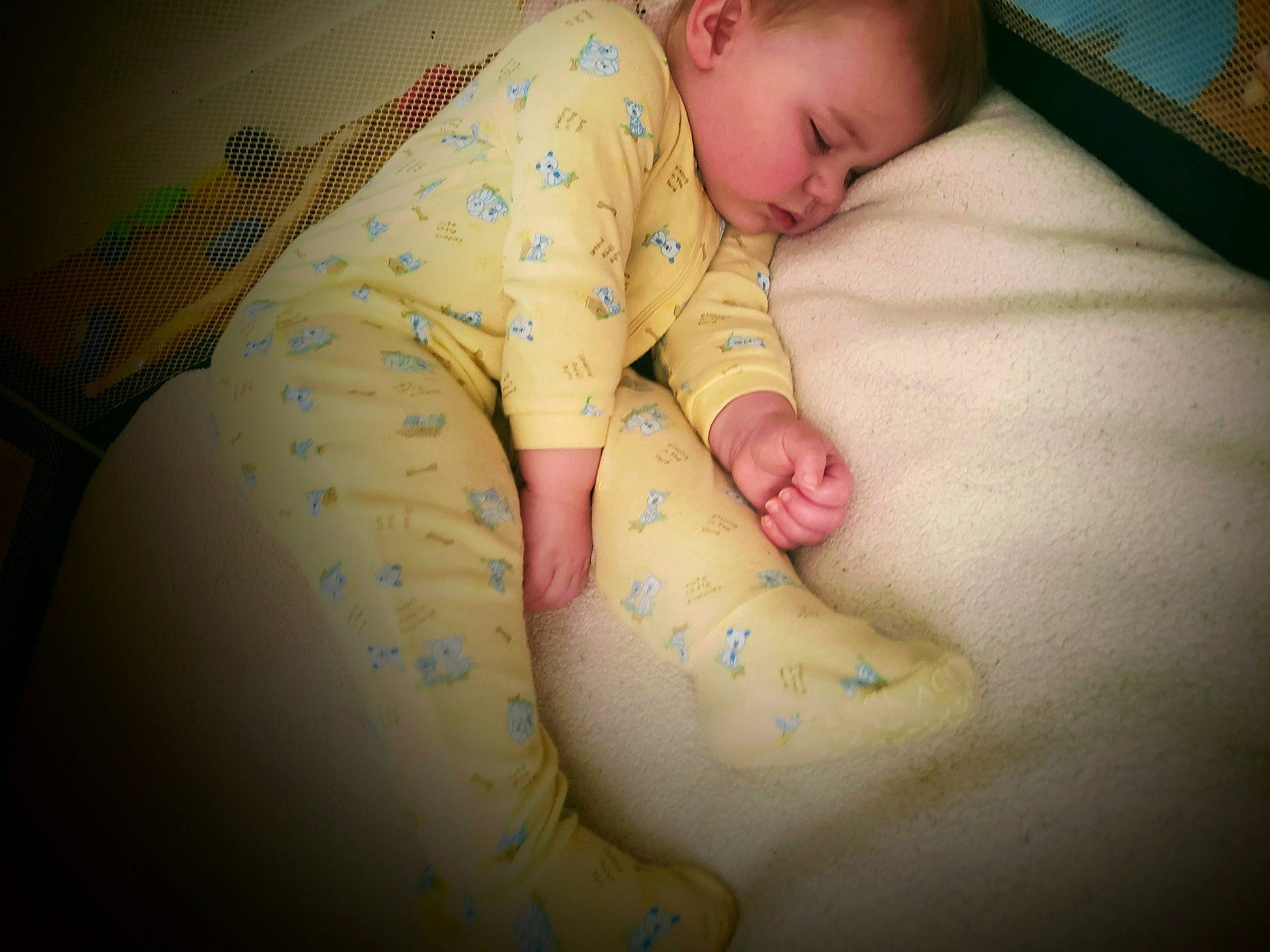 Phenix is registered to the contest to win money with this photo: abdomen, baby, bedtime, child, comfort, elbow, flooring, foot, human_body, human_leg, knee, leg, linens, mammal, person, room, skin, sleeve, stomach, toddler