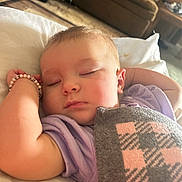 Wrynlee is registered to the contest to win money with this photo: arm, baby, blanket, bracelet, car_seat, carpet, child, cozy, face, indoor, infant, living_room, peaceful, portrait, purple_clothing, relaxation, sleeping, sofa, soft_light, wooden_furniture
