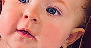 Wrynlee is registered to the contest to win money with this photo: baby, blue_eyes, brown_background, cheeks, child, close_up, clothing, curious_expression, cute, face, head, indoors, infant, leopard_print, person, portrait, sitting, skin, texture, young