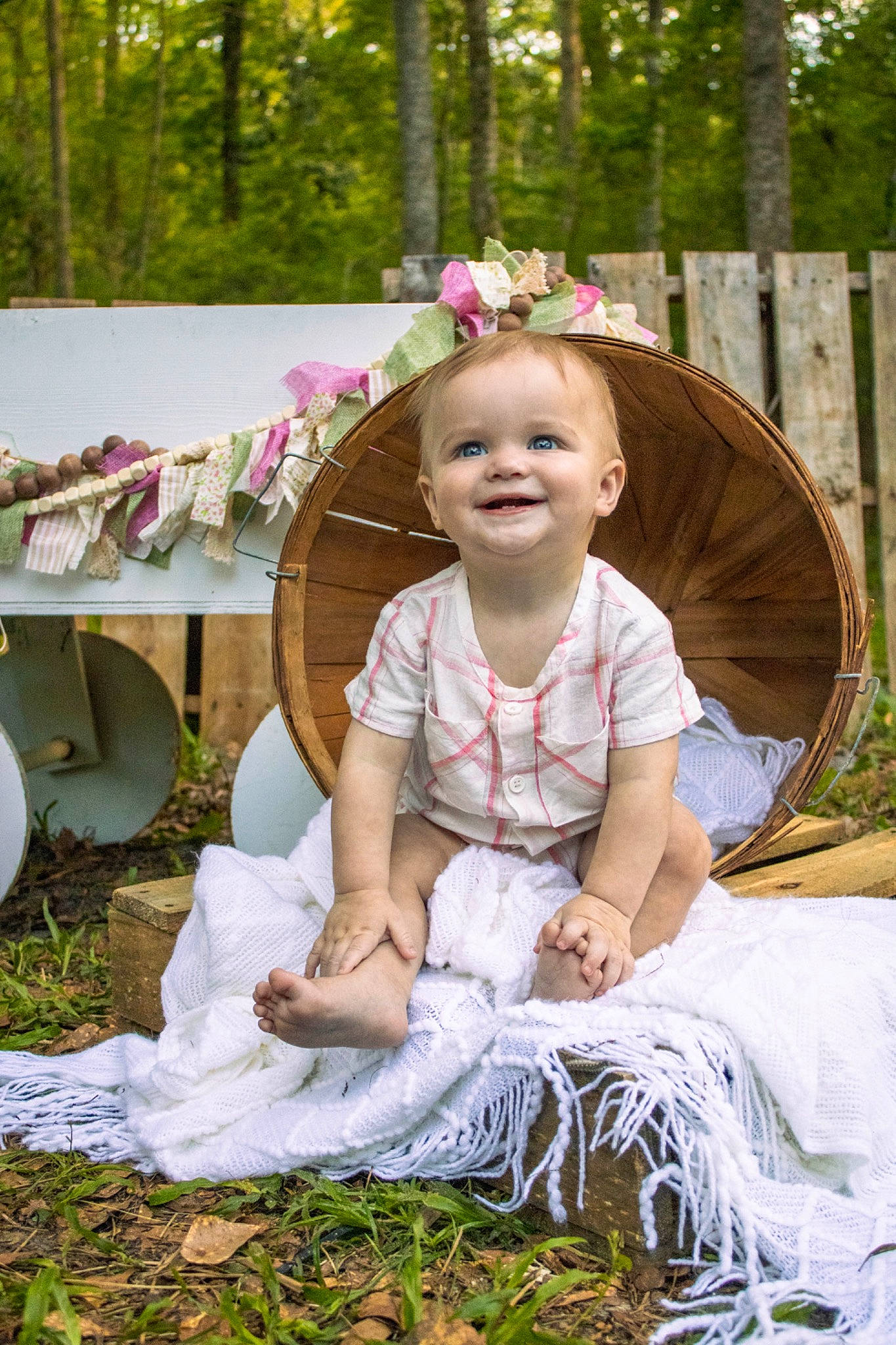 Elliott is registered to the contest to win money with this photo: chair, child, dress, event, face, facial_expression, fashion_accessory, fun, grass, hairstyle, happy, joy, leisure, people_in_nature, person, plant, sitting, smile, toddler, tradition
