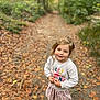 child, forest, autumn, leaves, path, sweater, skirt, boots, yellow_boots, smiling, outdoor, nature, fall, young_girl, person, happy, trees, seasonal, casual_clothing, daylight