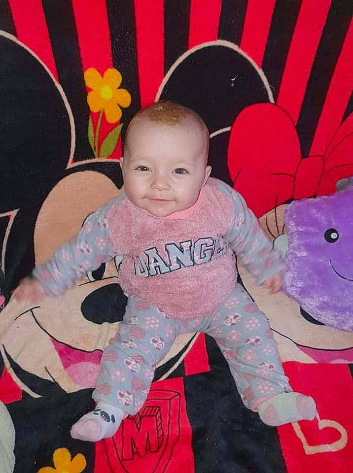Sarah participe au concours pour gagner de l'argent avec cette photo : baby, baby_products, baby_toddler_clothing, cheek, child, cool, curtain, facial_expression, fun, happy, magenta, pattern, person, pink, red, sitting, skin, sleeve, smile, sneakers