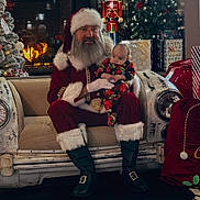 Arlo joined the competition — help win amazing prizes! baby, beard, boots, celebration, christmas_lights, christmas_tree, couch, festive_clothing, fireplace, glasses, gloves, holiday_decorations, indoor, nutcracker, presents, red_outfit, santa_claus, smiling, vintage_car, white_fur
