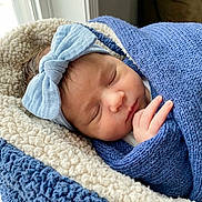 Lucas joined the competition — help win amazing prizes! newborn, baby, sleeping, blue_bow, blue_blanket, knit_blanket, cozy, soft_texture, cushion, window_light, indoor, peaceful, child, headband, wrapped, resting, infant, cute, portrait, closeup