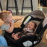 Aurora joined the competition — help win amazing prizes! baby, toddler, car_seat, indoor, carpet, pacifier, child, furniture, chair, floor, person, interaction, smile, happy, home, clothing, toy, hair, infant, carrying_device