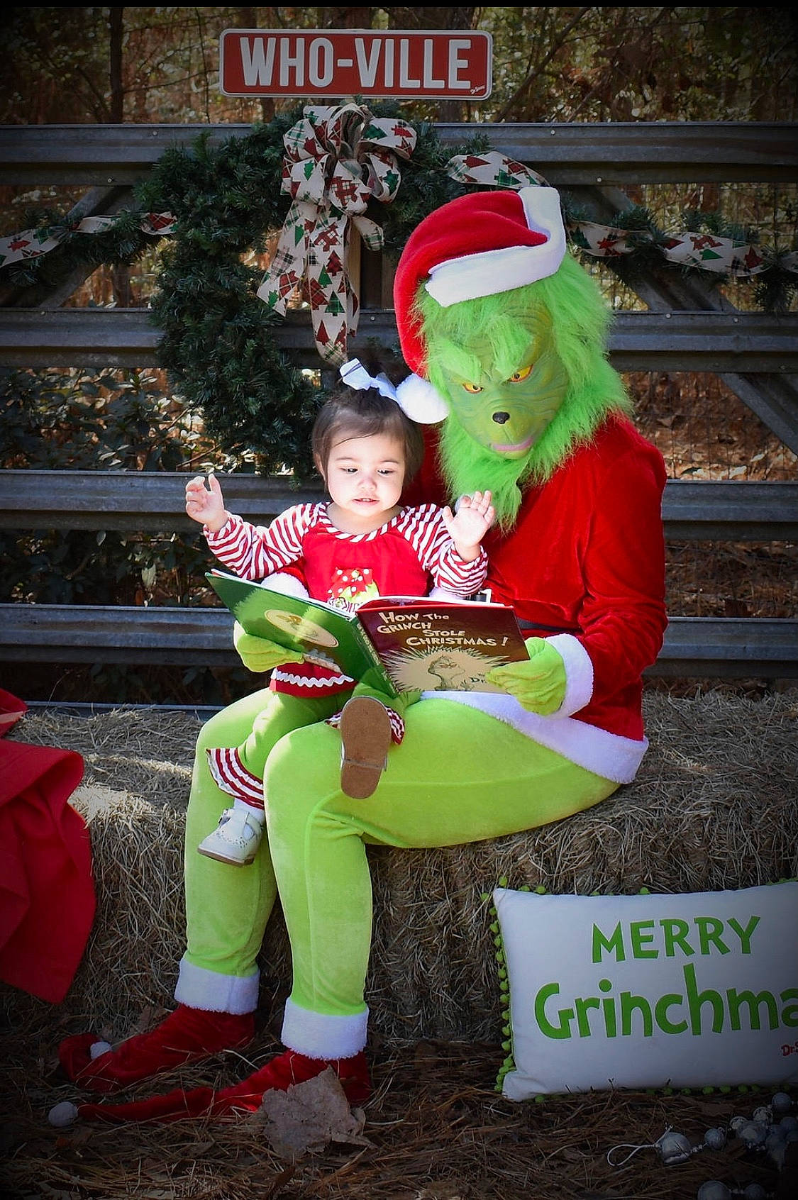 Cecilia joined the competition — help win amazing prizes! boot, carmine, christmas_decoration, costume_hat, event, fictional_character, fun, happy, hat, holiday, lap, leisure, person, plant, recreation, santa_claus, shoe, sitting, sneakers, toddler