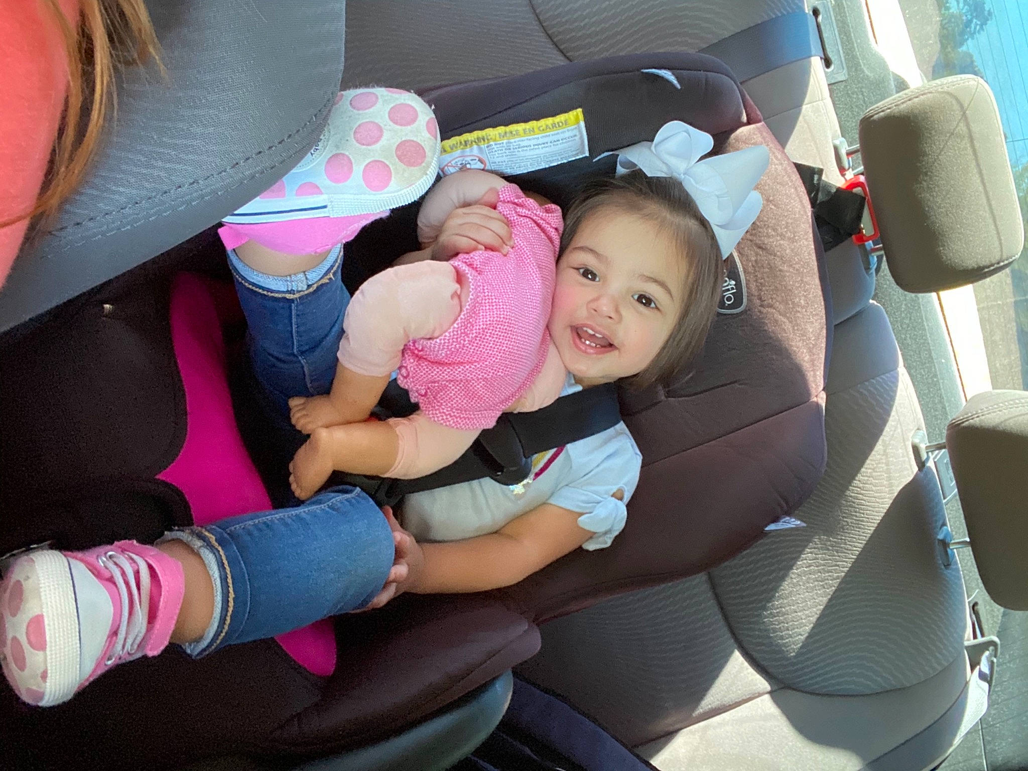 Cecilia joined the competition — help win amazing prizes! automotive_design, baby_in_car_seat, car, car_seat, car_seat_cover, comfort, finger, hand, head_restraint, human_body, leg, mode_of_transport, motor_vehicle, person, pink, product, seat_belt, smile, steering_part, vehicle