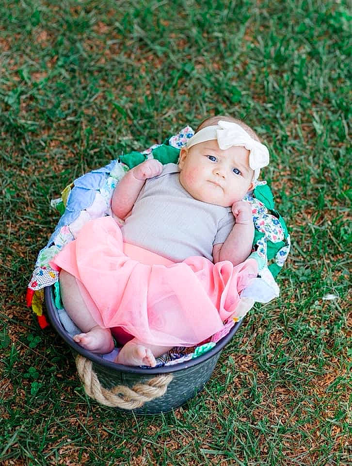 Brynn is registered to the contest to win money with this photo: baby, baby_carriage, baby_products, baby_toddler_clothing, cheek, child, comfort, event, fashion_accessory, grass, happy, headwear, lawn, leisure, pattern, people_in_nature, person, pink, portrait_photography, recreation