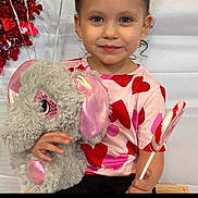 Novaleigh joined the competition — help win amazing prizes! child, girl, plush_toy, elephant, lollipop, heart_pattern, pink_shirt, red_hearts, smile, curly_hair, indoor, toy, cute, holding, sitting, childhood, portrait, happy, playful, decoration