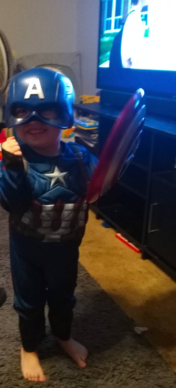 Kieran is registered to the contest to win money with this photo: captain_america, costume, electric_blue, fictional_character, games, headgear, headwear, helmet, person, personal_protective_equipment, play, suit_actor, superhero, toddler