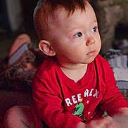 Declan joined the competition — help win amazing prizes! child, toddler, baby, portrait, indoor, red_shirt, sitting, looking_right, eyes, face, ear, short_hair, cozy, dim_light, candid, home_interior, hands, cute, expression, clothing