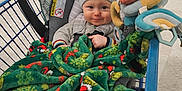 Declan joined the competition — help win amazing prizes! baby, blanket, child, clothing, colorful, comfort, cute, floor, happy, hat, indoor, infant, person, retail, seat, shopping, shopping_cart, smile, toy, winter_wear