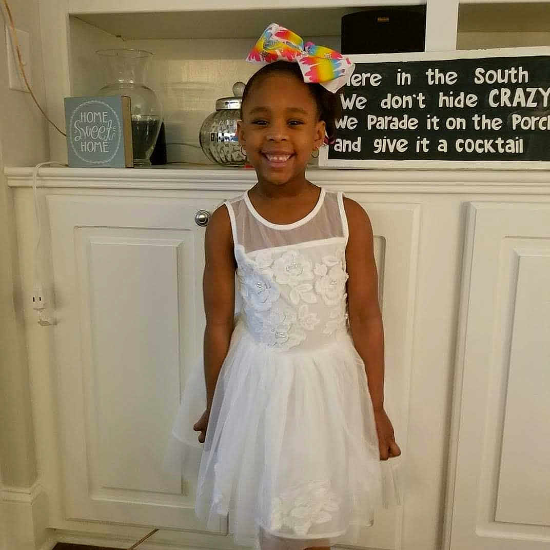 Patience is registered to the contest to win money with this photo: baby_toddler_clothing, bridal_party_dress, ceremony, child, clothing, costume, dress, flower_girl, formal_wear, hair_accessory, headpiece, joy, person, toddler, white