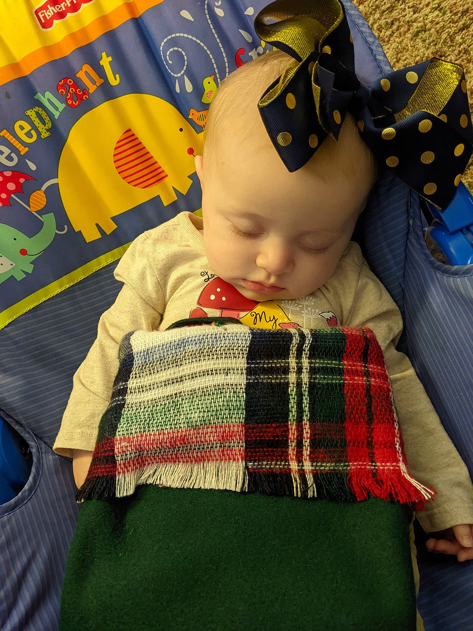 Genevieve joined the competition — help win amazing prizes! baby, baby_products, baby_toddler_clothing, cheek, child, comfort, fashion_accessory, flooring, knit_cap, linens, pattern, person, plaid, sitting, skin, sleeve, tartan, textile, toddler, wool