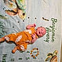 baby, infant, milestone_blanket, turtle, yellow_outfit, smiling, lying_down, months, name, decorative_blanket, child, cute, portrait, baby_clothing, marker, numbers, baby_boy, soft_texture, indoors, celebration