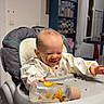Julian participe au concours pour gagner de l'argent avec cette photo : baby, high_chair, chocolate, messy, bottle, kitchen, food, smiling, face, child, meal, table, plastic_bottle, clothing, indoor, happy, feeding, person, smile, infant