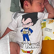 Jackson a rejoint le concours — aidez-le/la à gagner de superbes lots ! baby, newborn, sleeping, onesie, clothing, dragon_ball, character_print, blanket, mittens, pillow, cute, infant, peaceful, soft, indoors, laying_down, person, child, resting, sleep