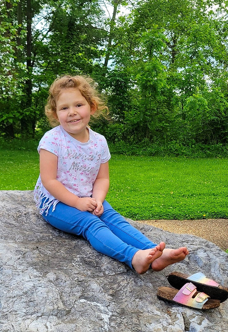 Raeleigh is registered to the contest to win money with this photo: blond, denim, electric_blue, fun, garden, grass, happy, human_leg, joy, leaf, leisure, pattern, people_in_nature, person, plant, recreation, sitting, smile, soil, thigh