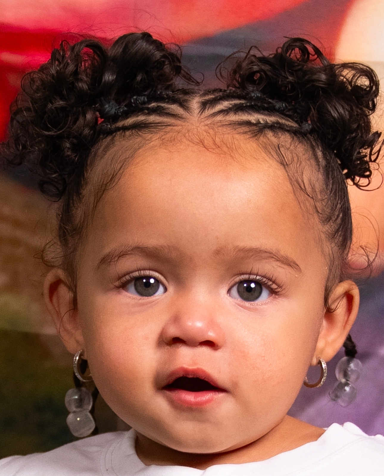 Yaziila is registered to the contest to win money with this photo: toddler, child, portrait, face, curly_hair, ponytails, hoop_earrings, beaded_earrings, expression, open_mouth, close_up, indoor, soft_lighting, cute, young, person, fashion, hairstyle, skin, eyes
