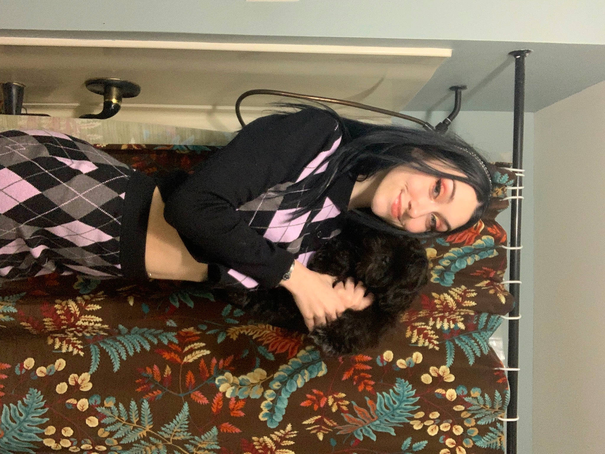 Malcolm joined the competition — help win amazing prizes! bed, bedding, black_hair, comfort, couch, flooring, fun, fur, hair, linens, long_hair, outerwear, pattern, picture_frame, plaid, room, smile, tartan, thigh, vintage_clothing