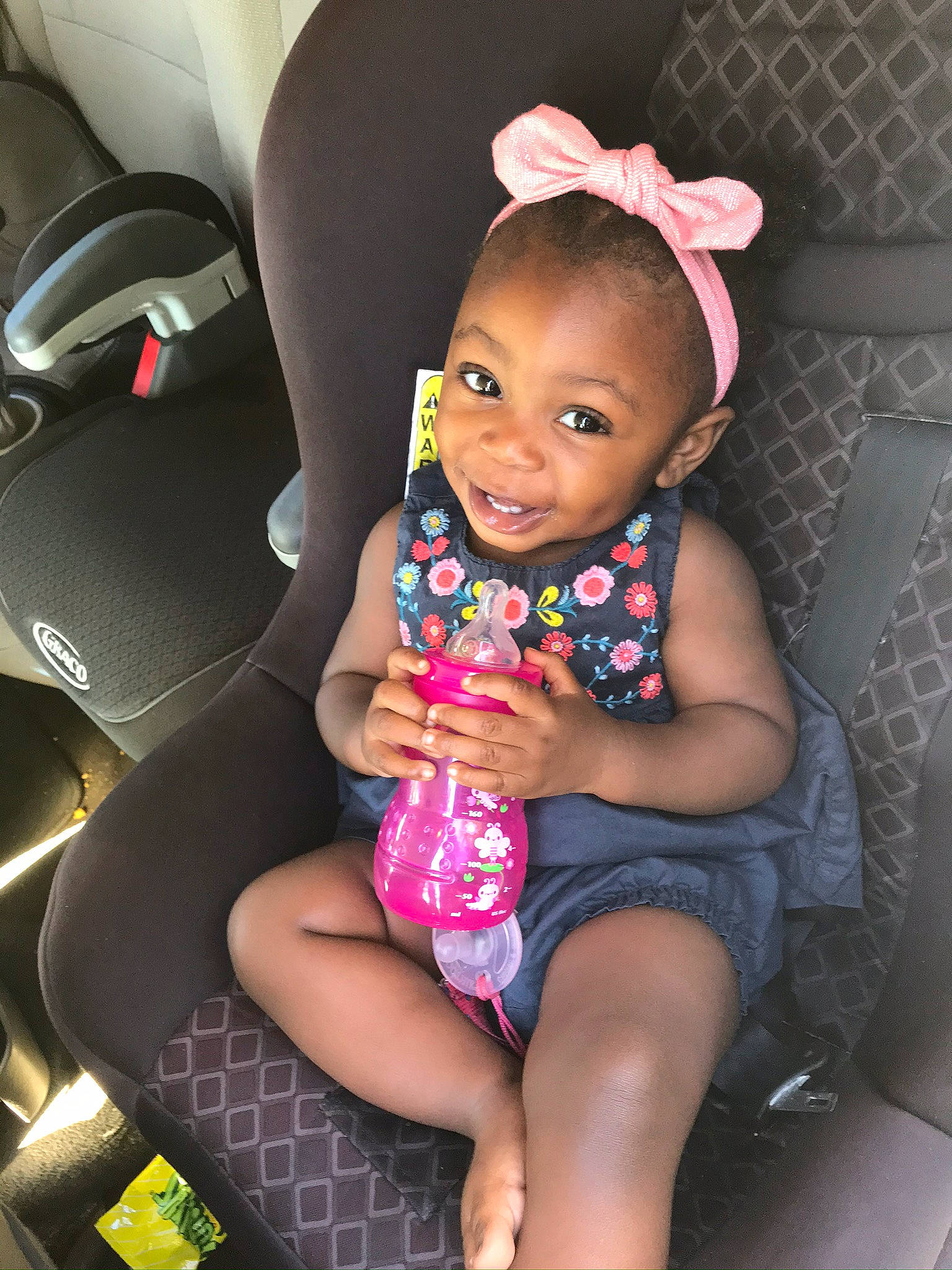 Jazlyn joined the competition — help win amazing prizes! auto_part, baby, car_seat, cheek, child, ear, fun, hair_accessory, joy, leg, person, pink, sitting, skin, toddler