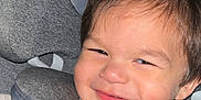 Xavier joined the competition — help win amazing prizes! toddler, child, car_seat, smile, face, safety_belt, clothing, indoors, cute, happy, seatbelt, portrait, baby, car, head, person, young_child, seat, sitting, closeup