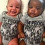 baby, infant, toddler, smiling, serious, onesie, clothing, gray, text, video_games, controller, cute, sitting, blanket, indoors, two_babies, diversity, portrait, holding_hands, closeup