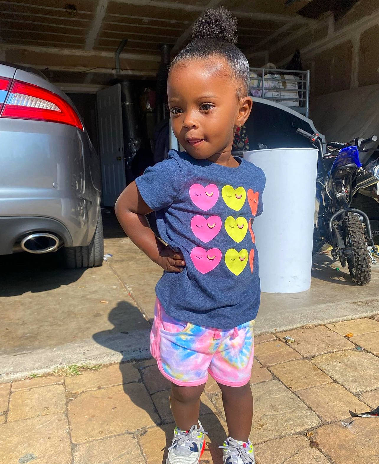 Analaya is registered to the contest to win money with this photo: automotive_design, automotive_exterior, automotive_lighting, automotive_tire, car, hairstyle, happy, human_settlement, leisure, motor_vehicle, person, pink, shoulder, standing, t_shirt, tire, toddler, trunk, vehicle, vehicle_door