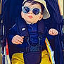 Ilan Bounia participe au concours pour gagner de l'argent avec cette photo : baby, child, stroller, sunglasses, hat, cap, yellow_pants, blue_jacket, book, outdoor, sunny, cute, fashion, portrait, infant, person, seatbelt, cool, baby_accessory, casual
