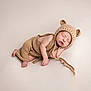 newborn, baby, sleeping, knitted_clothing, bear_ears, cute, infant, soft_texture, cozy, hat, resting, portrait, peaceful, child, toddler, neutral_background, cute_outfit, small_hands, small_feet, wearing