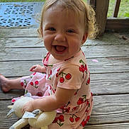 Kharmyn joined the competition — help win amazing prizes! toddler, child, smiling, dress, cherry_pattern, toy, plush_toy, wooden_floor, porch, outdoor, sunlight, happy, sitting, snacks, curly_hair, playtime, cute, person, daylight, nature