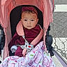 baby, child, stroller, pink, blanket, headband, sitting, portrait, face, eyes, infant, outdoor, sidewalk, pavement, harness, clothing, calm, wheel, pushchair, walk