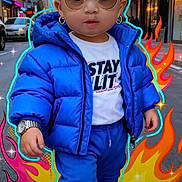 Jewlz is registered to the contest to win money with this photo: child, toddler, street, city, urban, puffer_jacket, blue_clothing, sunglasses, fashion, portrait, standing, serious_expression, storefronts, buildings, road, phone_screenshot, lock_screen, flame_graphics, colorful, outdoor