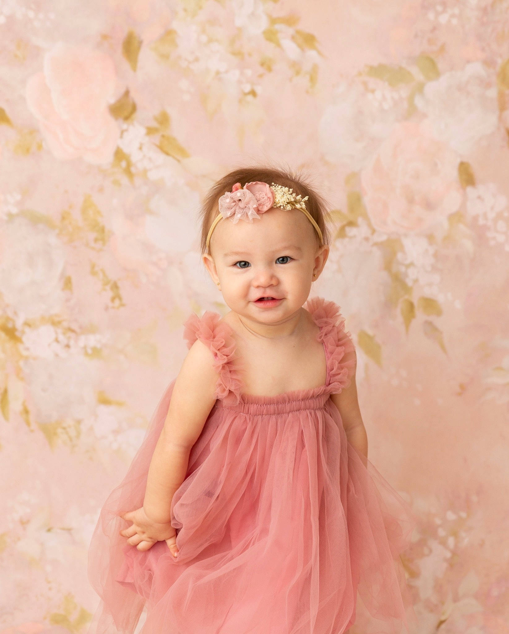 Valencia is registered to the contest to win money with this photo: baby, baby_toddler_clothing, blond, bridal_accessory, day_dress, dress, embellishment, flash_photography, hair_accessory, happy, headband, headpiece, one_piece_garment, pattern, peach, person, petal, pink, sleeve, smile
