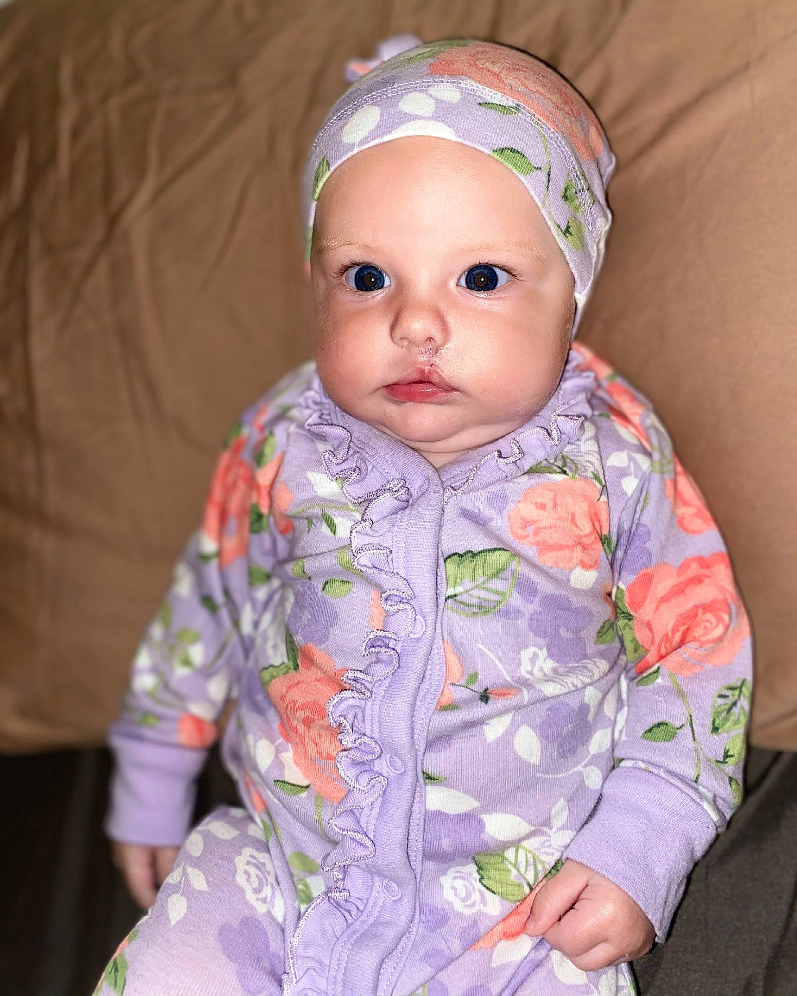 Brayleigh is registered to the contest to win money with this photo: baby, baby_toddler_clothing, cap, cheek, chin, comfort, dress, eye, face, head, headwear, human_body, iris, lip, nose, outerwear, person, pink, skin, sleeve