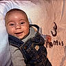 Zaylen is registered to the contest to win money with this photo: baby, infant, child, smiling, portrait, lying_down, denim, overalls, sweater, blanket, bed, soft_fabric, indoor, close_up, face, happy, clothing, brown_hair, photography, cozy
