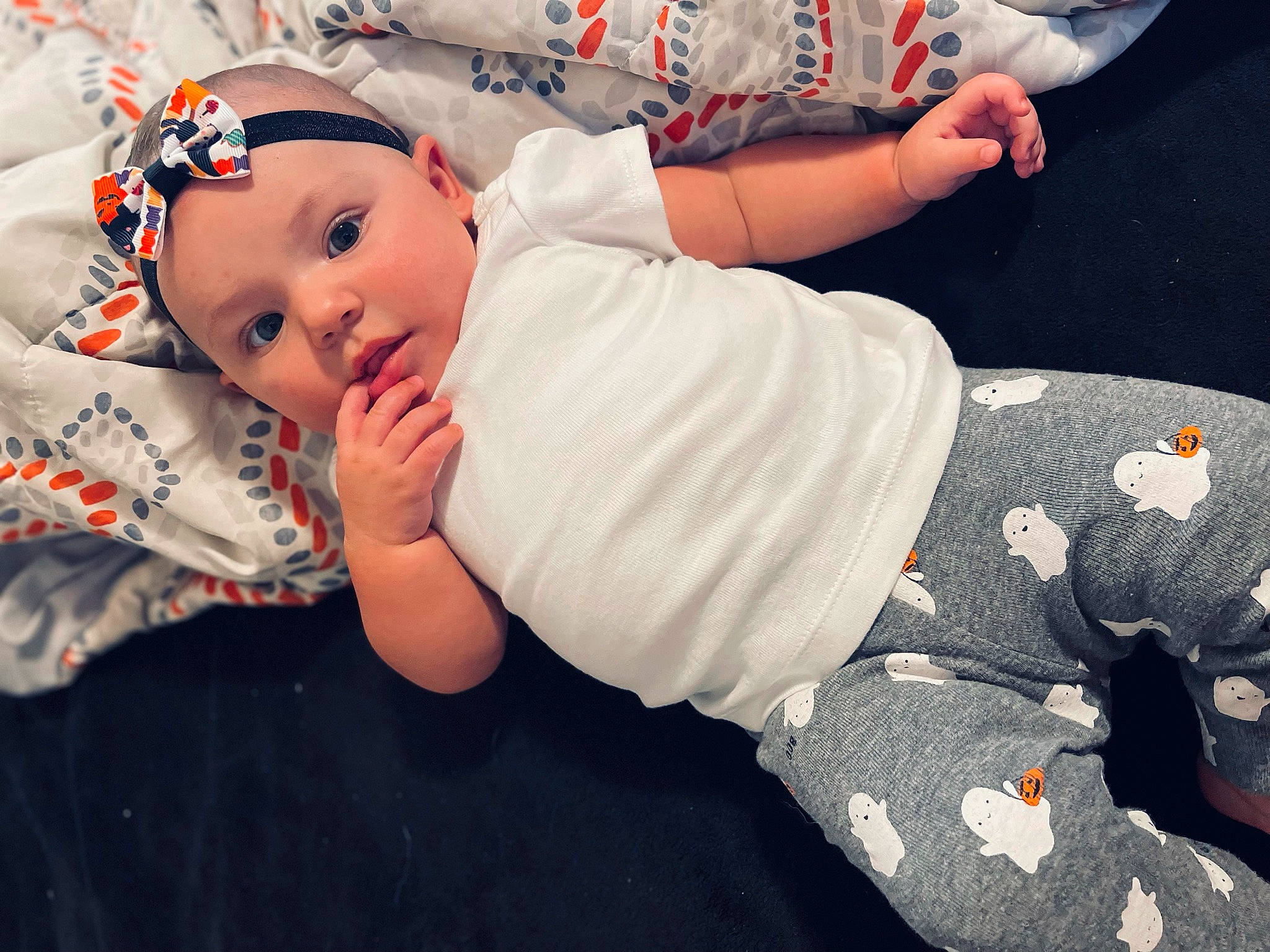 Raven is registered to the contest to win money with this photo: baby, baby_products, baby_sleeping, baby_toddler_clothing, child, comfort, elbow, fun, grass, happy, headwear, human_leg, knee, linens, pattern, person, sitting, sleeve, sock, t_shirt